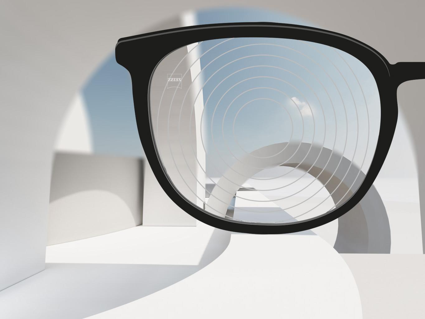 Eine Nahaufnahme von ZEISS Brillengläsern für das Myopie-Management mit schwarzer Brillenfassung und konzentrischen Kreisen auf der Glasoberfläche. 