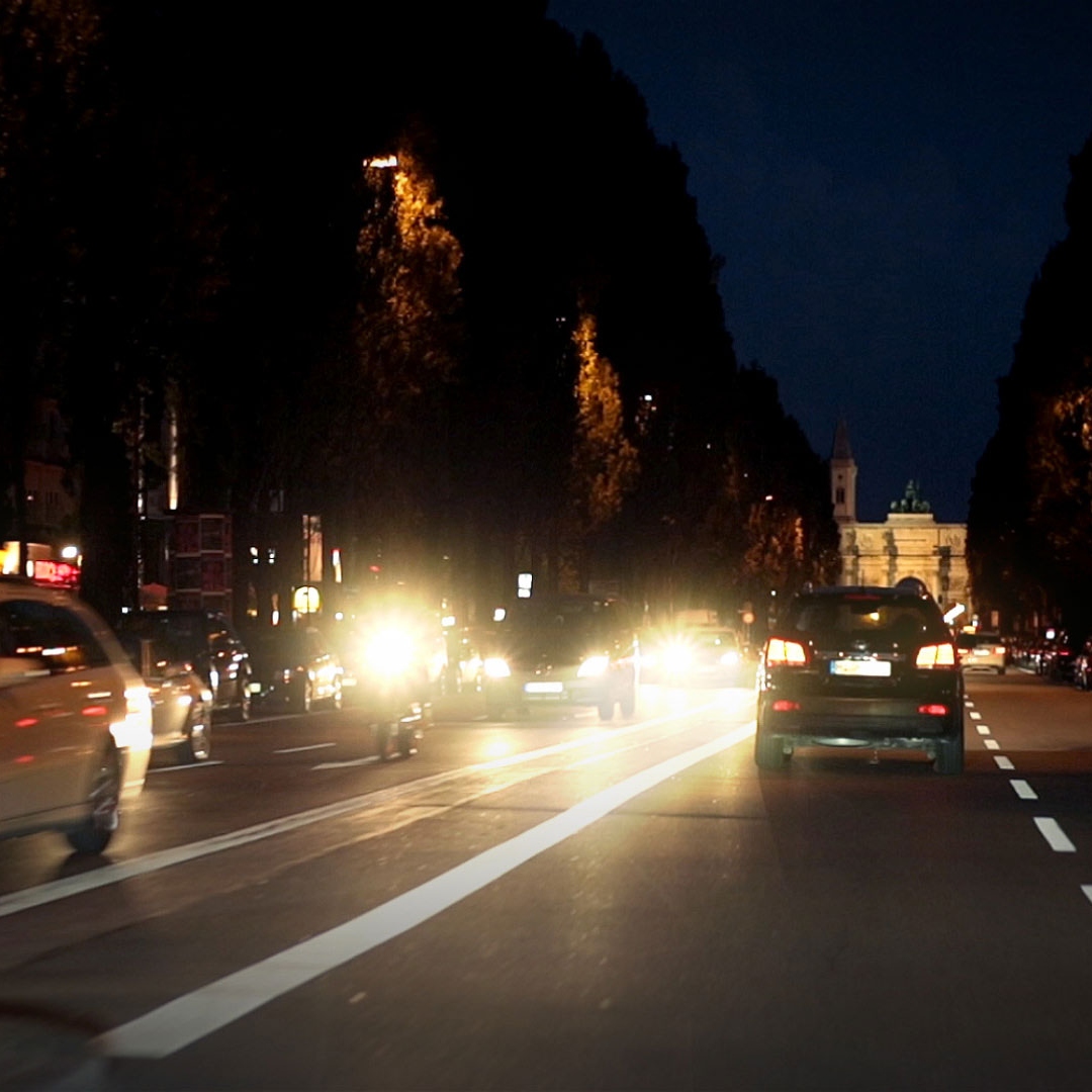 Blendung in der Nacht durch die Scheinwerfer entgegenkommender Fahrzeuge und durch nasse Straßen 
